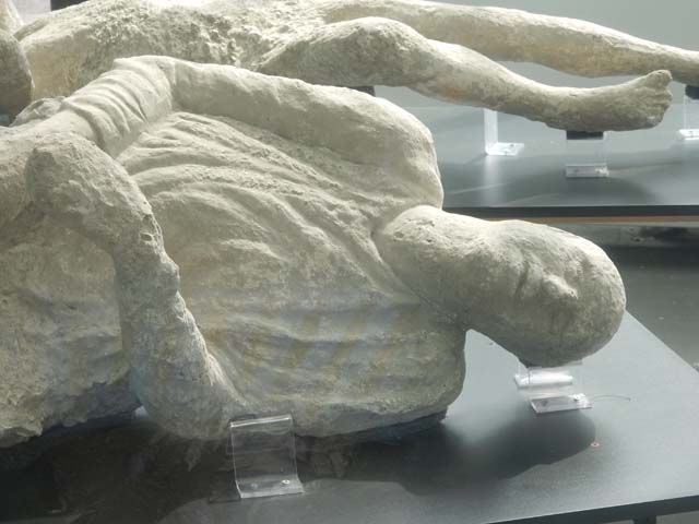 Pompeii Stabian Gate. September 2015. Victim number 15.
Plaster cast of victim numbered 15 by Dwyer, and 14 by Garcia y Garcia, a woman of mature age. 
Exhibit from the Summer 2015 exhibition in the amphitheatre.
