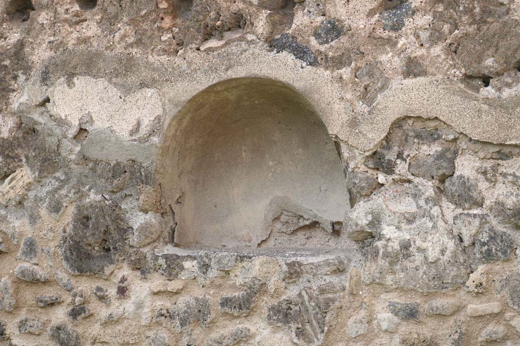 VII.12.12 Pompeii. December 2018. Arched niche in west wall. Photo courtesy of Aude Durand.
According to Boyce –
above the counter on which the articles for sale were displayed, was an arched niche (h.0.52, w.0.60, d.0.25, h. above floor 1.48).
Fiorelli described this as “la nicchia de’ Penati”.
Fiorelli, Scavi, 19; Descrizione, 283.
See Boyce G. K., 1937. Corpus of the Lararia of Pompeii. Rome: MAAR 14. (p.70, no.317) 
