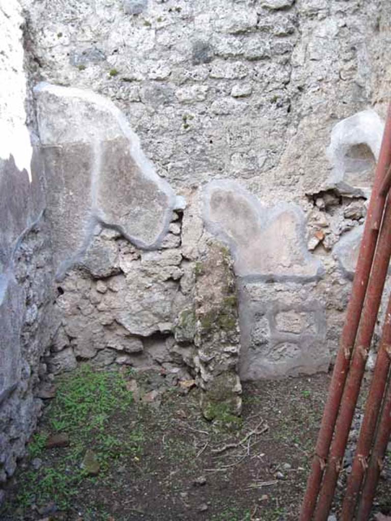 .2.18/19 Pompeii. September 2010. 
Looking south into small room in south-east corner. Latrine and kitchen? Photo courtesy of Drew Baker.
According to Fiorelli, the room with the latrine had a hollow in the wall for placing a lamp.  
See Pappalardo, U., 2001. La Descrizione di Pompei per Giuseppe Fiorelli (1875). Napoli: Massa Editore. (p.36)
According to Boyce, in the south-west corner of the kitchen, built in a peculiar manner, was an arched niche.
(height 0.30m, w.0.30m, d.0.25m, height above the floor 1.30m).
See Boyce G. K., 1937. Corpus of the Lararia of Pompeii. Rome: MAAR 14. (p.22, no.12B). 


