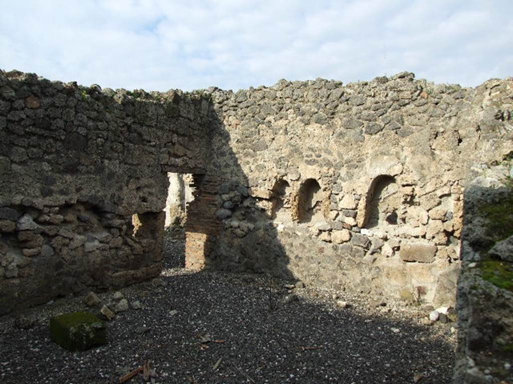 I.3.8b Pompeii. December 2006. North-west corner of kitchen on east side, through hole in wall from I.3.25.
According to Boyce, two arched niches were found on the north wall of the kitchen.
The niches were 0.58 high and 0.36 wide, 0.30 deep and 1.10 above the floor.
The niches were side by side, and 0.60 apart.
He said Fiorelli described them as “nicchie per i domestici Lari”.
See Boyce G. K., 1937. Corpus of the Lararia of Pompeii. Rome: MAAR 14. (p. 24, no.23)
See Giacobello, F., 2008. Larari Pompeiani: Iconografia e culto dei Lari in ambito domestico. Milano: LED Edizioni, (p.134, no.5)


