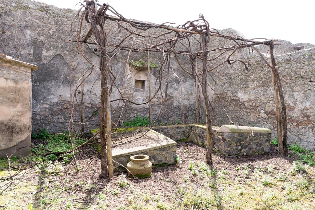 I.13.2 Pompeii. March 2023. 
Looking south across summer triclinium towards south wall with lararium niche. Photo courtesy of Johannes Eber.

