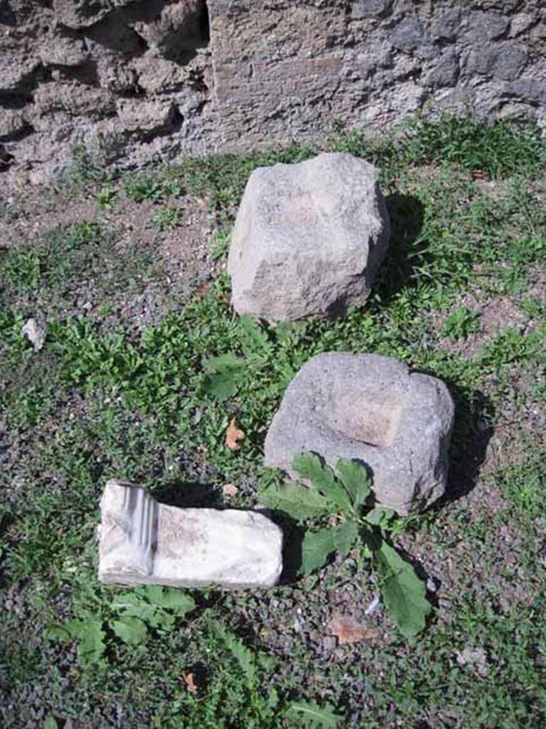 I.1.4 Pompeii. September 2010. Detail of marble leg and basalt door bar receivers. Photo courtesy of Drew Baker.
