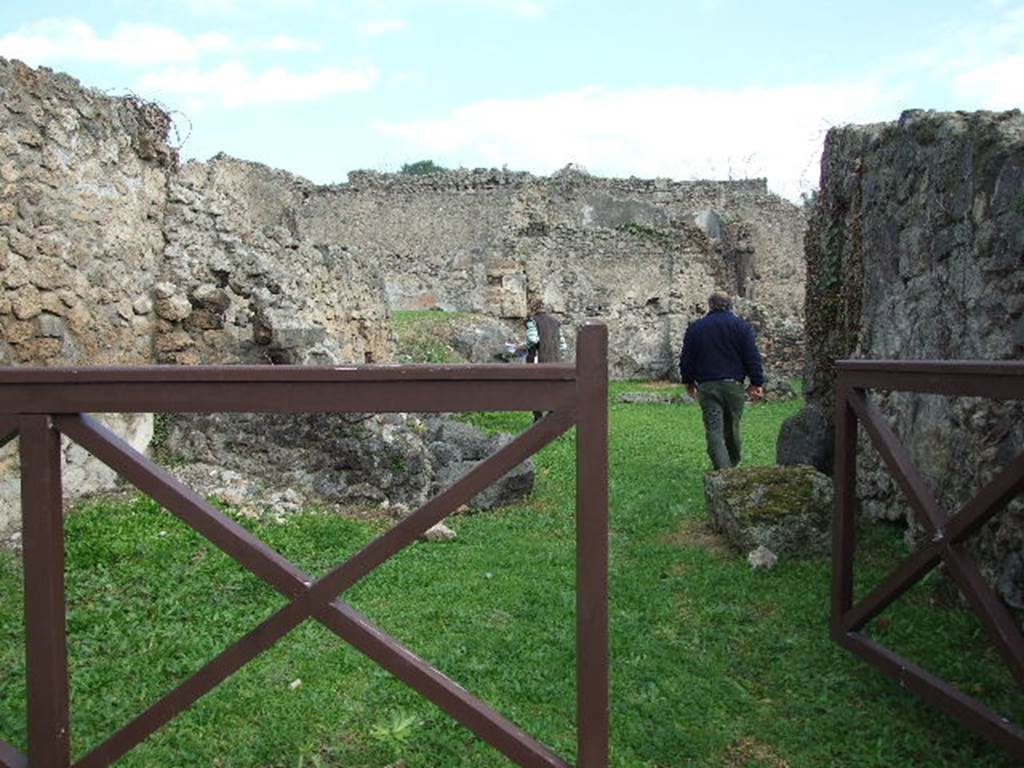 I.2.4 Pompeii. December 2006. Looking east across shop, towards the ruined wall separating it from the atrium of I.2.3.  
