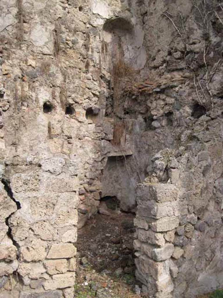 1.2.6 Pompeii. September 2010. Looking north-east through doorway, across small room. In the north-east corner, two recessed features parallel to each other on different floors (latrine nitch?) can be seen on the north wall.  Photo courtesy of Drew Baker.
