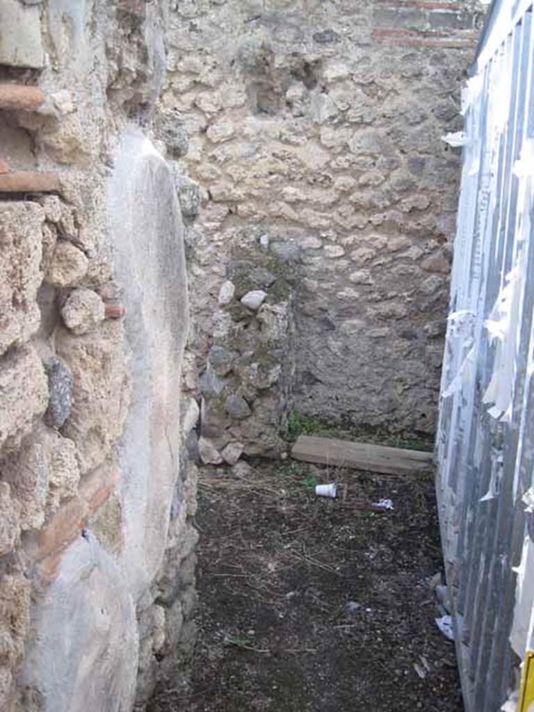 I.2.18 Pompeii. September 2010. Looking west across rear of bar from near room in south-east corner, towards doorway to rear room in south-west corner (centre left). Photo courtesy of Drew Baker.
