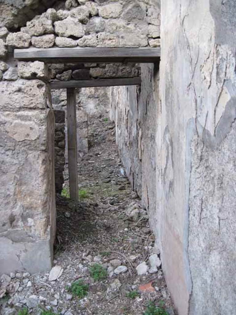 I.2.24 Pompeii. September 2010. Doorway in north wall of large room.
Looking north through doorway to corridor and rooms on the north side.The stairs to the upper floor are through the doorway on the left side. Photo courtesy of Drew Baker.
