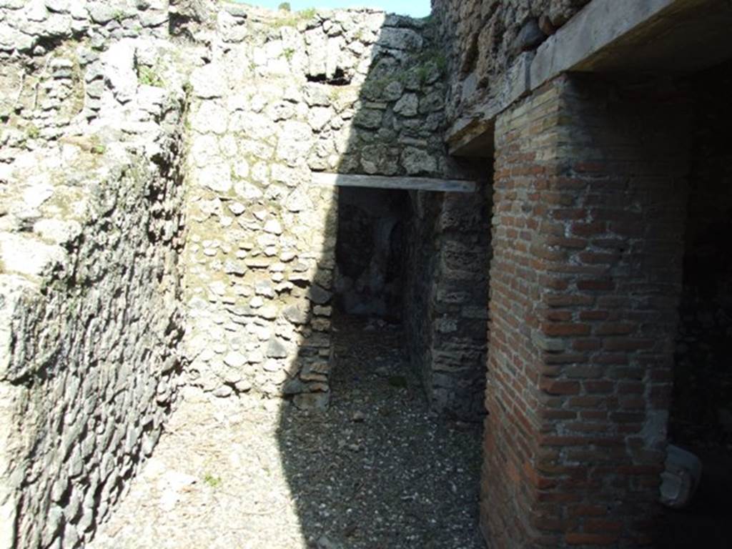 I.3.31 Pompeii. March 2009.  Looking east along wider corridor below another corridor (now collapsed) in south-west corner of upper peristyle. According to Fiorelli, the upper corridor had a sloping floor.
