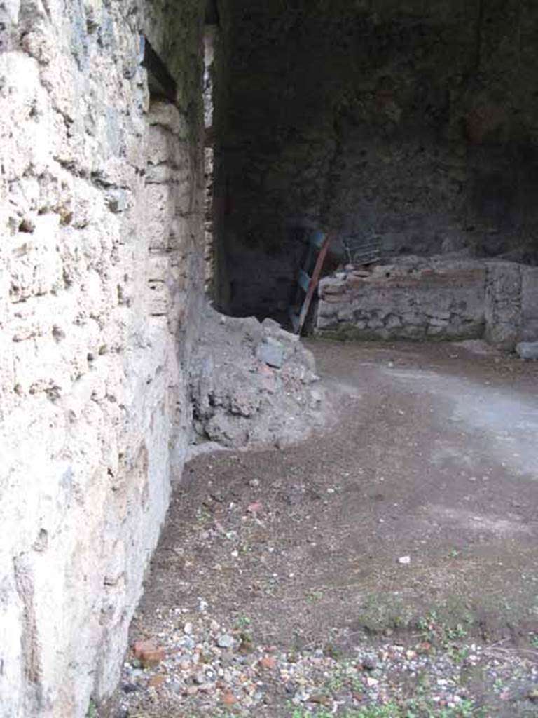 I.5.2 Pompeii. September 2010.  North wall (end) of east portico looking north towards feature of remains of lararium. Photo courtesy of Drew Baker.
