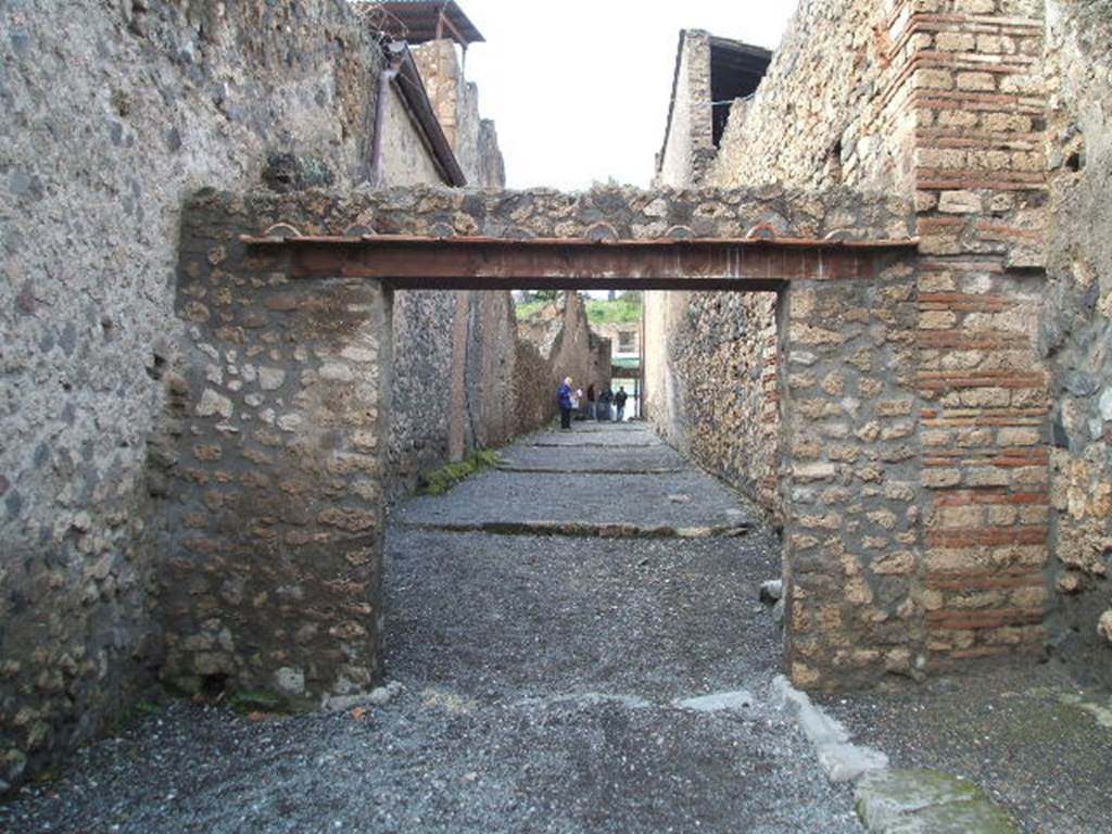 I.6.2 Pompeii (Side wall, on left). Vicolo di Paquius Proculus looking north, I.7 on right.