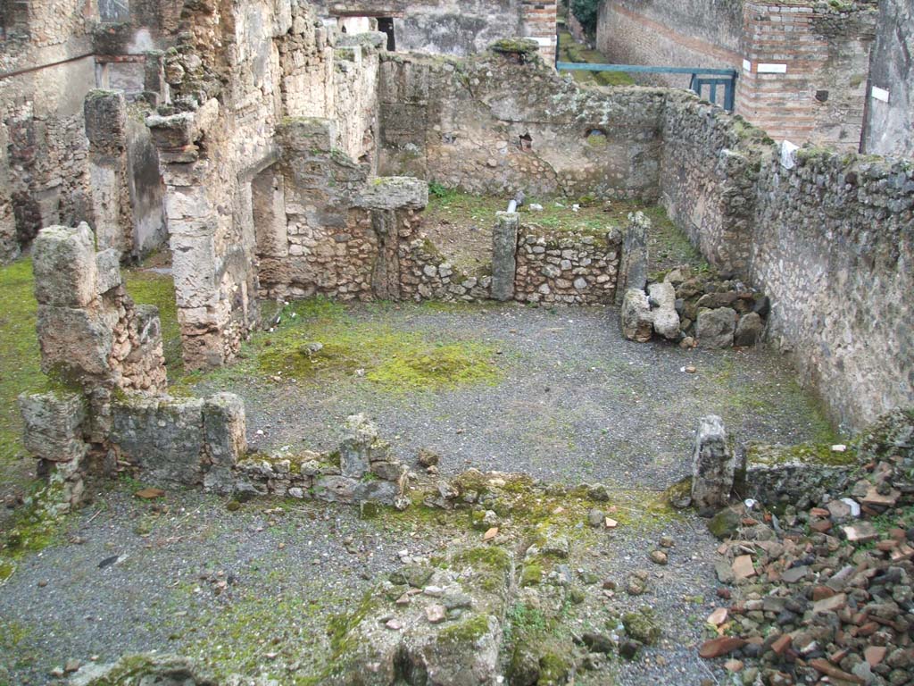 I.6.13 Pompeii. December 2004.  West side looking south, photo taken from rear of I.6.11.
Triclinium 4 would appear to be the large room across the centre of the photo.
Room 7 can be seen on the lower left, room 10 on the lower right.
On the north side of room 10, (but not in the above photo) would have been a small room.
This was described on page 433 of Notizie degli Scavi, 1929, -
as a second corridor f used to separate the narrow rooms 8-9-10 and corresponding to a side doorway to the western vicolo, with a wooden staircase giving access to the upper floor, a doorway that would have been closed or abolished at the time of the abandonment of the house, after the 63 earthquake.
Room 9 would have been a small room in the north-west corner of the house.
