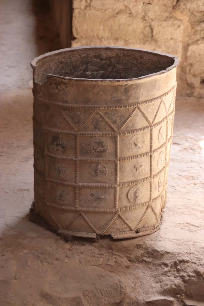 I.7.3 Pompeii. September 2019. Cylindrical lead bucket with relief of zodiac signs, in atrium. 
Photo courtesy of Klaus Heese. 
