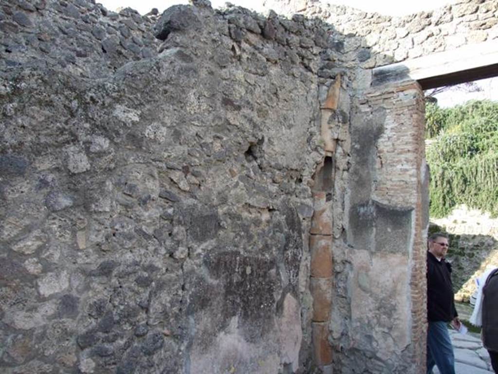 I.7.8 Pompeii. December 2007. West wall and downpipe from upper floor in north-west corner.