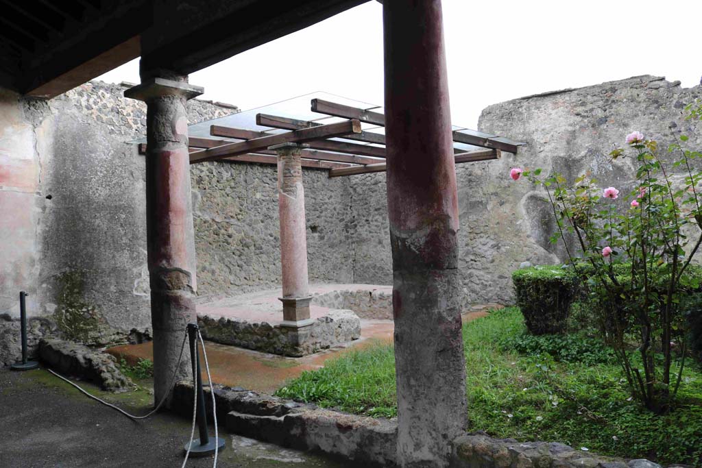 I.8.9 Pompeii. March 2010. Room 9 and garden area with restored triclinium.  
Photo courtesy of Rick Bauer.
