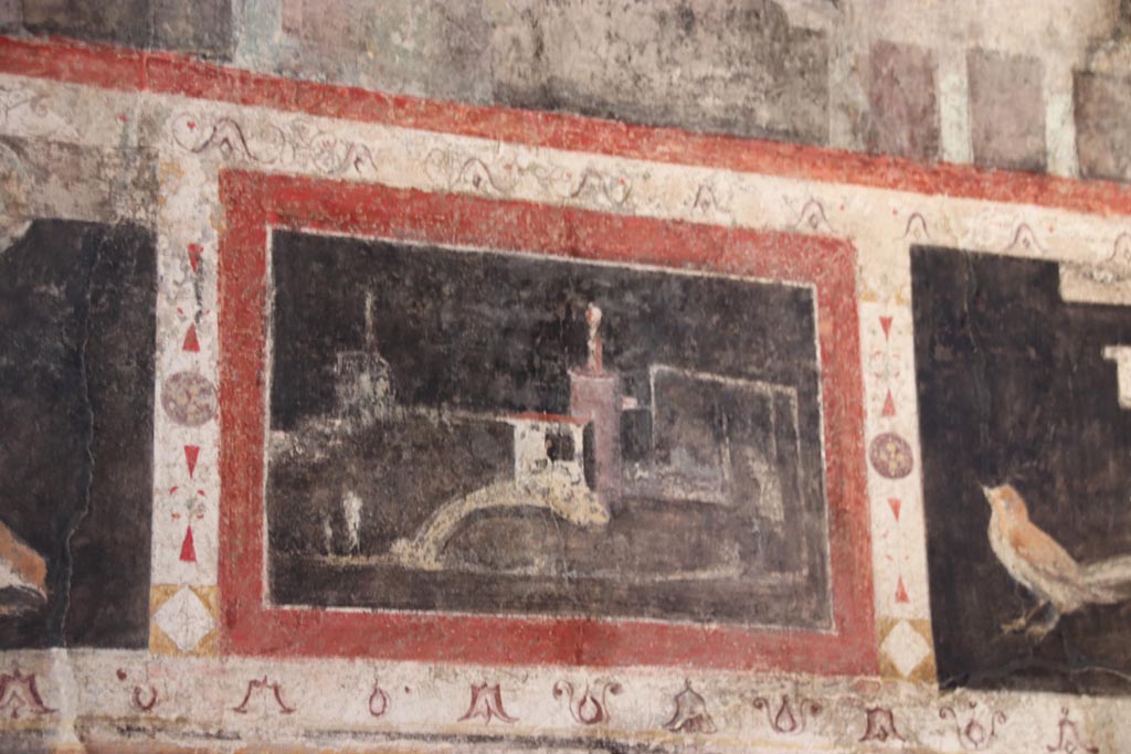 I.9.5 Pompeii. October 2023. 
Room 10, triclinium, detail from upper centre of west wall on south side of central painting. Photo courtesy of Klaus Heese.
