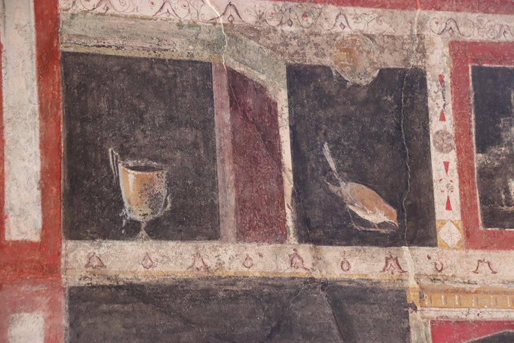 I.9.5 Pompeii. October 2024. Room 10, triclinium, detail from south side of upper centre of east wall. Photo courtesy of Klaus Heese