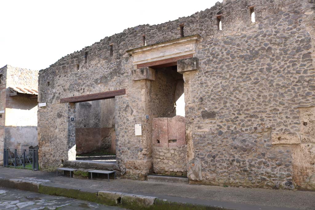 I.9.6 Pompeii. December 2018. 
Entrance doorway on left next to small roadway. Entrance doorway to I.9.5 with plaster cast of doors, in centre.
Photo courtesy of Aude Durand.
