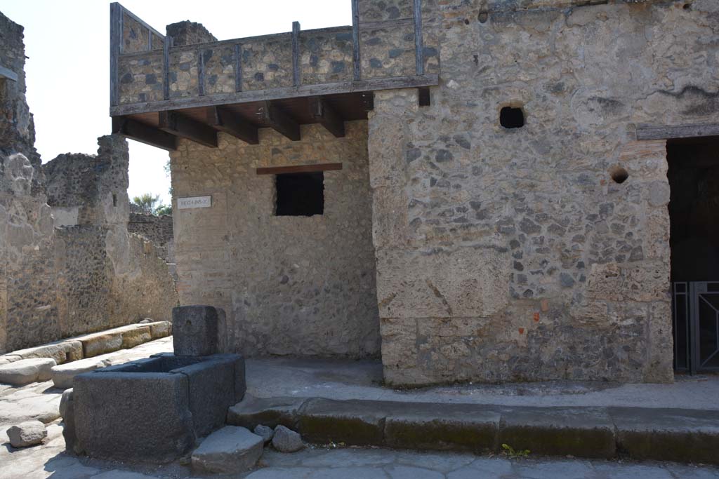 I.10.1 Pompeii, on right. April 2017. 
Looking south in Vicolo del Menandro, towards fountain at junction with Vicolo di Paquius Proculus (on left).
Photo courtesy Adrian Hielscher.
