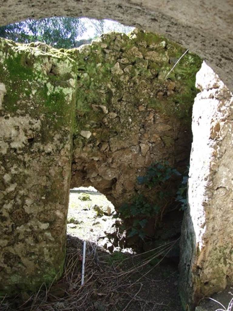 I.10.4 Pompeii. March 2009. Looking out from third lower floor storeroom C. Latrine? Wall dividing lower floor rooms and outside area. According to Allison, The fixtures in this room [C] included a latrine in the northwest corner, ostensibly outside this room. See Allison, P.M., Pompeian Households: An online companion. http://www.stoa.org/projects/ph/rooms?houseid=9#212 (Room C).