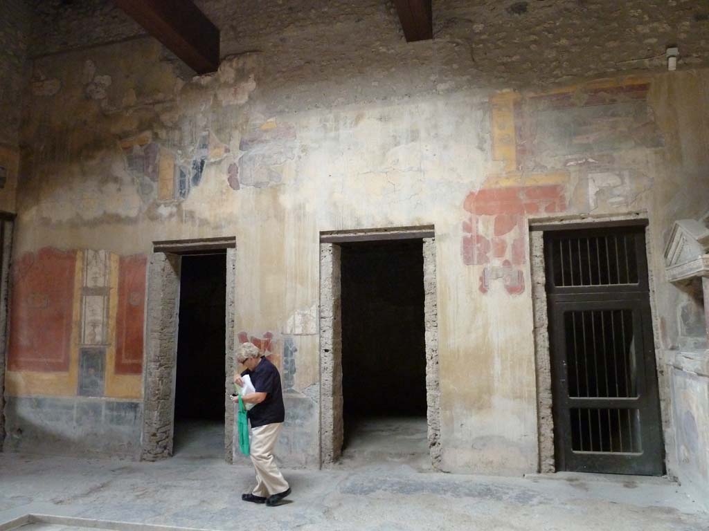 I.10.4 Pompeii. May 2010. West side of atrium, with doorways to rooms 7, 6 and 5.