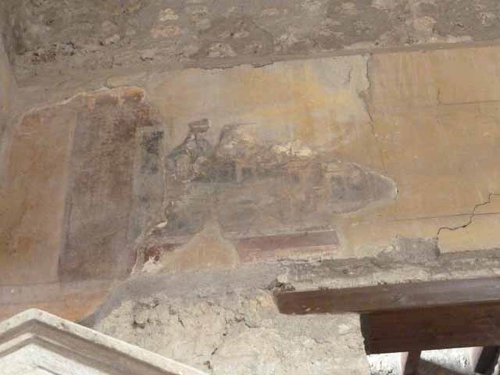 I.10.4 Pompeii. May 2010. North wall of atrium, on the west side. Painted panel with architectural scene on upper north wall.