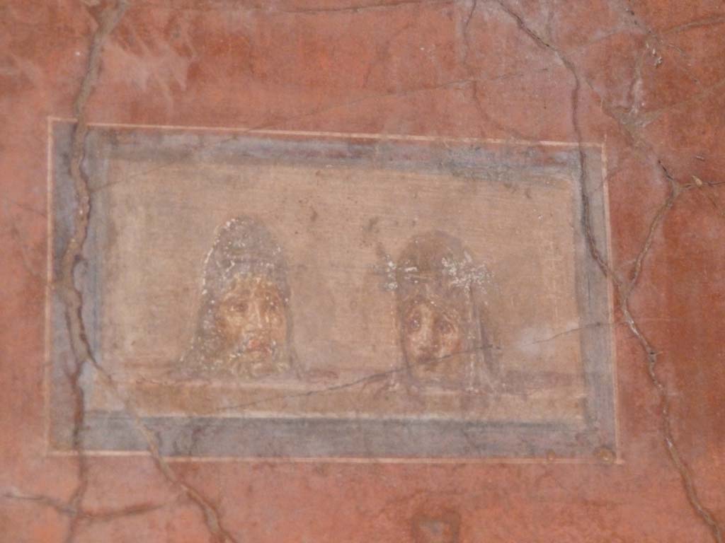 I.10.4 Pompeii. May 2015. North wall in north-east corner of atrium, detail of painted panel with theatrical masks. Photo courtesy of Buzz Ferebee.
