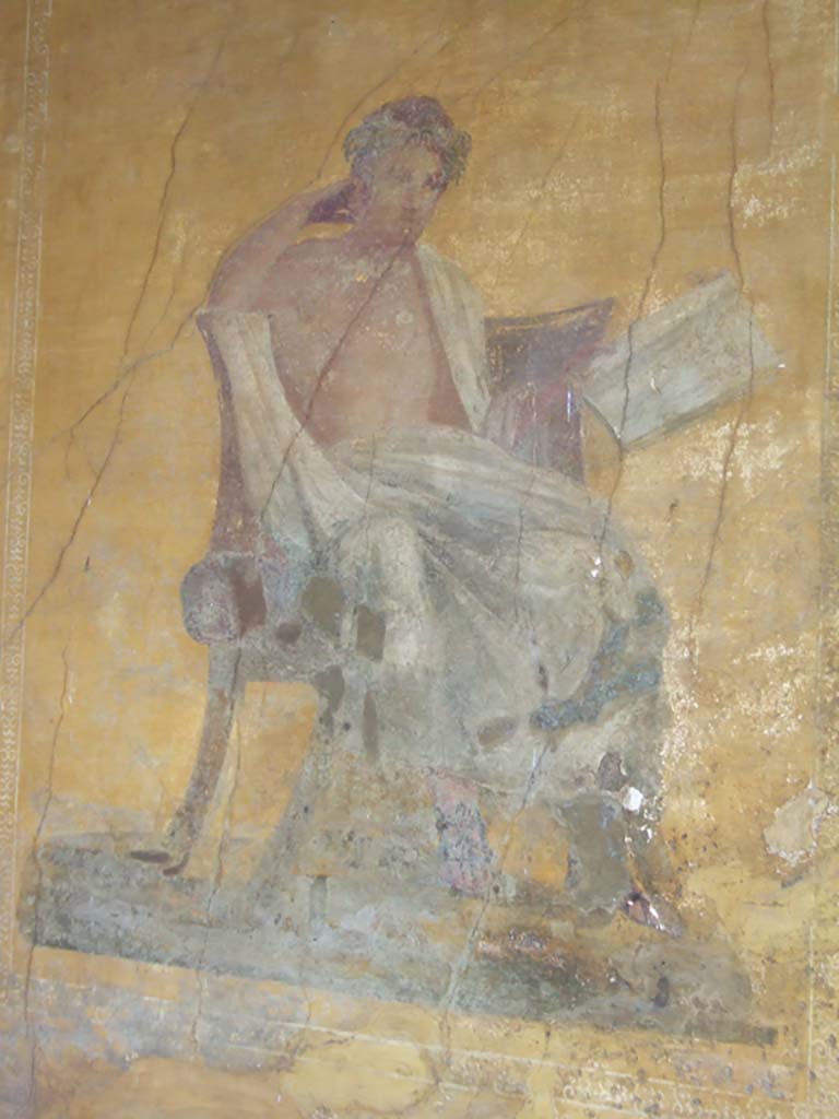 I.10.4 Pompeii. May 2006. Alcove 23, wall painting of poet. 
The name of Menander was inscribed by the painter on the skirt of the man’s cloak. (CIL IV 7350a) 
See Cooley, A. and M.G.L., 2004. Pompeii: A Sourcebook. London: Routledge. (p. 70) 
