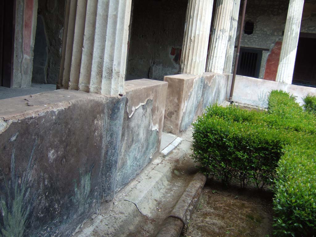 I.10.4 Pompeii. May 2012. Looking towards north portico and painted pluteus, with terracotta puteal, on left.  Photo courtesy of Buzz Ferebee.
