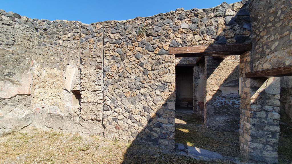 I.11.1 Pompeii. July 2021. 
Looking north from room on south side of bar-room, looking towards doorway to cubiculum and ala, centre right. 
The doorway on the right led into the room with the benches and lararium.
Foto Annette Haug, ERC Grant 681269 DÉCOR.
