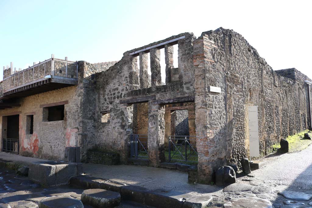 I.12.3, on left, I.12.2 and I.12.1 Pompeii. December 2018.
Looking towards entrances on Via dellAbbondanza. Photo courtesy of Aude Durand.
