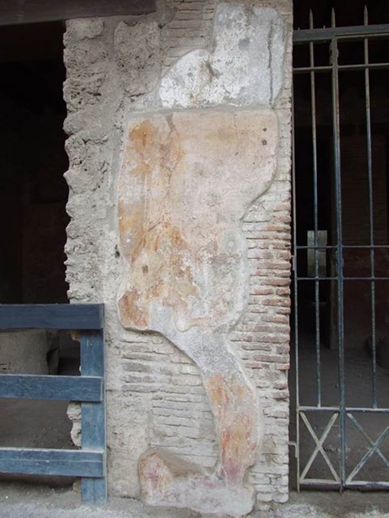 I.12.3 Pompeii.  December 2006.  Plaster on wall to east of door.