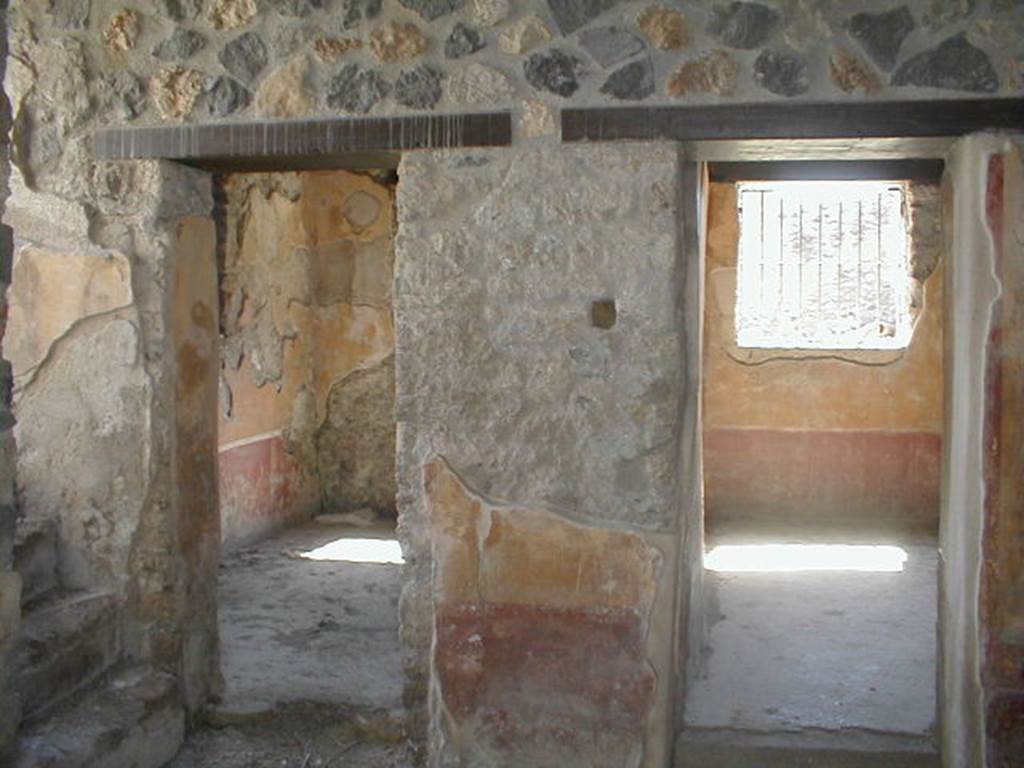 I.13.9 Pompeii. May 2005. Doorways in west wall of atrium, to oecus on the left, and to triclinium on the right.