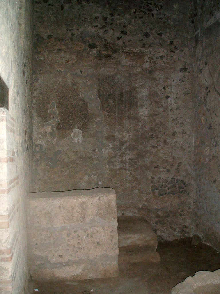 I.15.3 Pompeii. December 2004. 
Room 9. Kitchen looking west to steps to upper floor. The doorway to the latrine is on the left.
