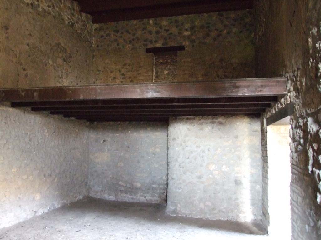 I.15.3 Pompeii. December 2007. Room 11 in south-west corner of peristyle, next to kitchen. 
The stairs in the kitchen, room 9, would have led to the door on the upper floor. Looking north.
