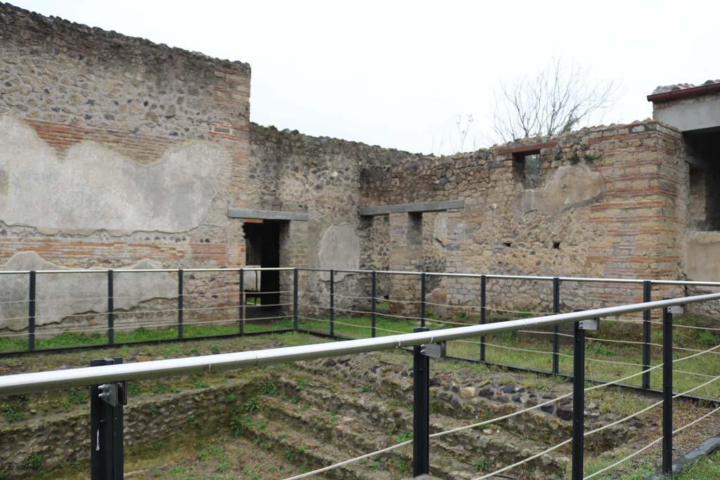 II.4.6 Pompeii. December 2018. 
Looking north-west across swimming pool, towards doorway into portico of baths’ area, with 11.4.7, on right. Photo courtesy of Aude Durand.
