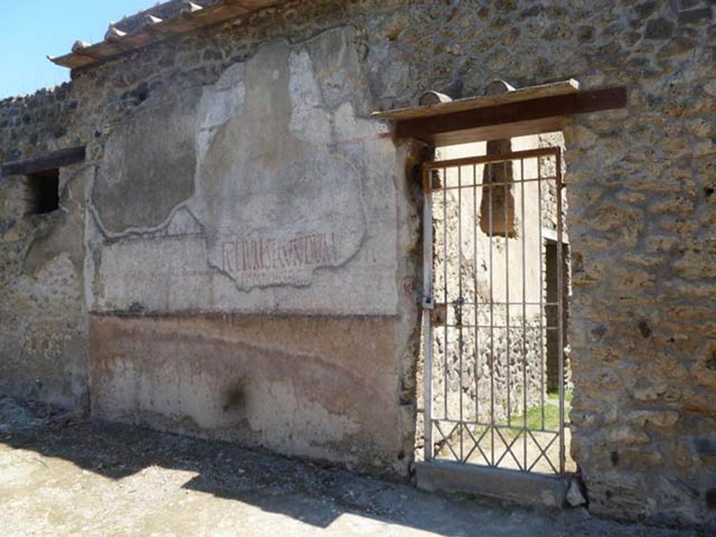 II.4.10 Pompeii. May 2011. 
Exterior west wall in Vicolo di Giulia Felice, on north side of doorway, showing multiple layers of graffiti or painted plaster.
L. Ceium Secundum aed… can be clearly read.  Photo courtesy of Michael Binns.


