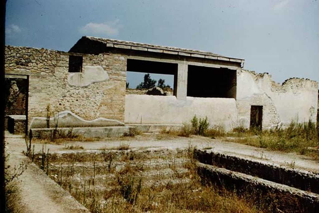 II.4.6 Pompeii. October 2022. 
Looking west across garden area towards swimming pool, with 11.4.7, on right. Photo courtesy of Klaus Heese.
