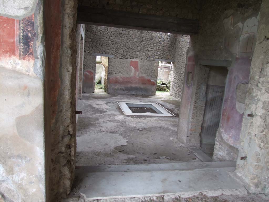 II.4.6 Pompeii. December 2006. Leaving Domus at II.4.10, entering corridor on west side of II.4.6. Looking north. 