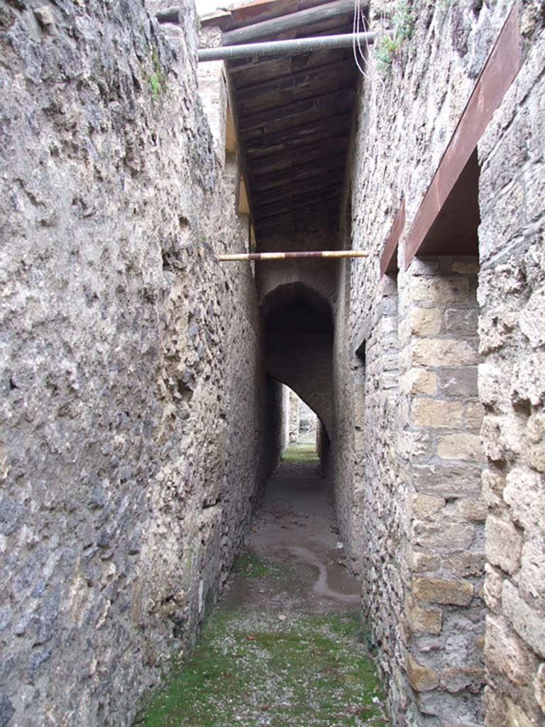 II.4.6 Pompeii. December 2006. Corridor to rear of nymphaeum, with blocked door in outside wall, looking north.