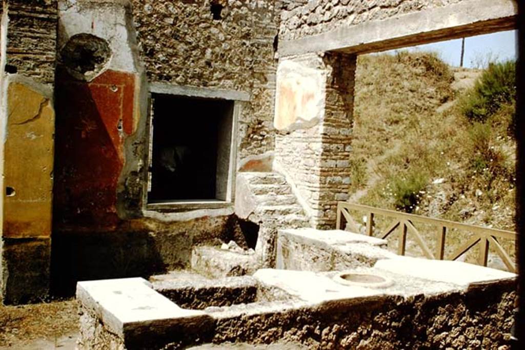 II.4.7 Pompeii. 1959. Looking north-west along counter towards five stuccoed masonry steps for storage of drinking and eating vessels. Photo by Stanley A. Jashemski.
Source: The Wilhelmina and Stanley A. Jashemski archive in the University of Maryland Library, Special Collections (See collection page) and made available under the Creative Commons Attribution-Non Commercial License v.4. See Licence and use details.
J59f0151
