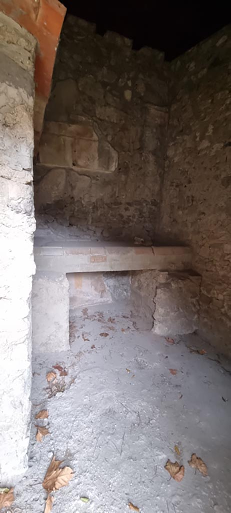 II.9.4 Pompeii. December 2023.
Looking north through doorway towards kitchen bench/hearth. 
Photo courtesy of Miriam Colomer.
