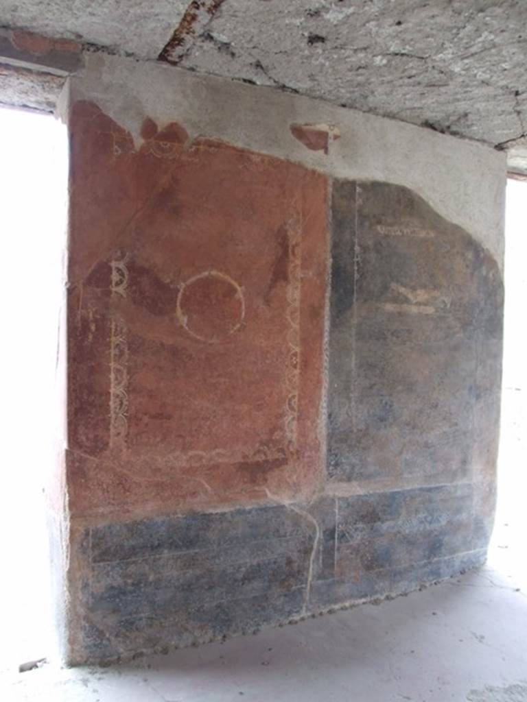 III.4.3  Pompeii.  March 2009. Room 3.  Triclinium.   Remains of painted panels on north wall, on east side of window, and near doorway.