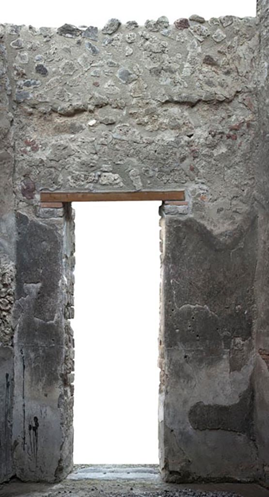 V.1.3 Pompeii. 2012. 
Room 7, east wall with doorway into atrium. 
Photo by Hans Thorwid.
“E wall in 2012. Restored parts of the wall photographed and merge with the lower part and floor line of earlier photos from 2005-7.”
Photo and words courtesy of the Swedish Pompeii Project.
