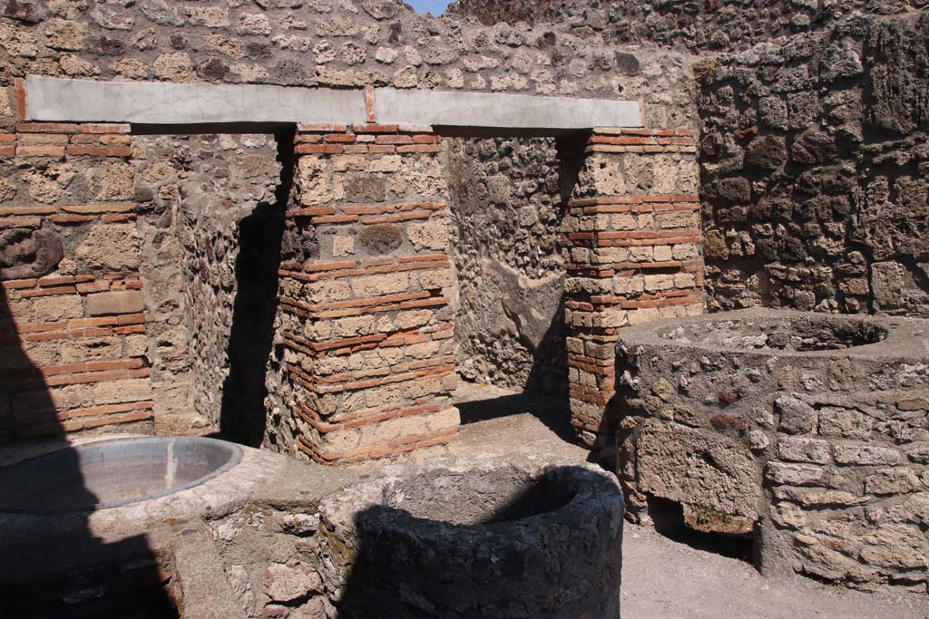 V.1.4 Pompeii. September 2021. 
Looking towards north wall with two doorways to rear rooms, and north-east corner of front room. Photo courtesy of Klaus Heese.
