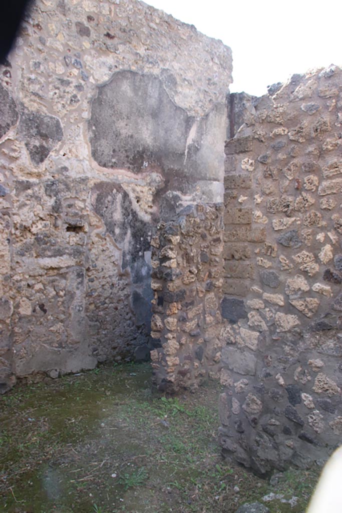 V.1.11 Pompeii. October 2023. 
Looking south-west from entrance doorway, towards doorway under stairs to upper floor.
At the rear is the corridor, leading west. Photo courtesy of Klaus Heese.
