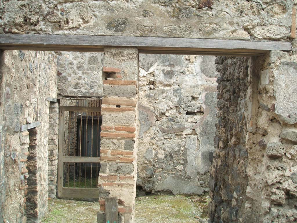 V.1.11 Pompeii, on left.                    May 2005.                     V.1.12, steps to upper floor, on right.