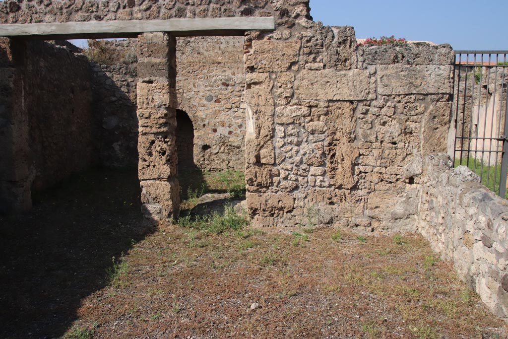 V.2.3 Pompeii. October 2023. Looking towards north side of bar-room, with doorways to two rear rooms. Photo courtesy of Klaus Heese.