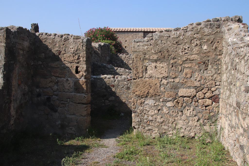 V.2.6 Pompeii. October 2023. Looking towards north wall of shop-room with doorway to rear room. Photo courtesy of Klaus Heese.