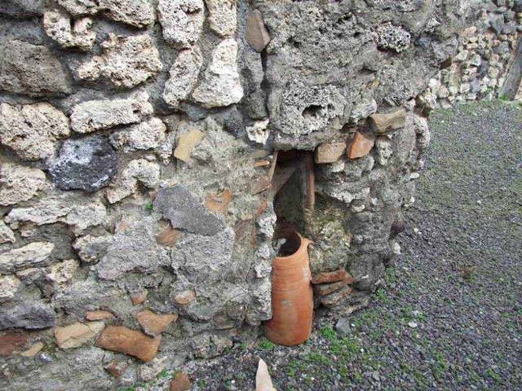 V.2.9 Pompeii. March 2009. Downpipe from upper floor in east wall of rear room.