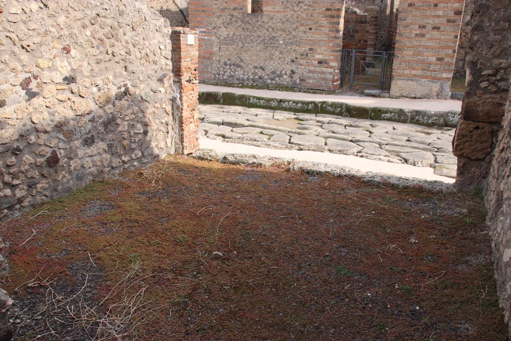 V.2.9 Pompeii. October 2022. Looking south across shop-room towards Via di Nola. Photo courtesy of Klaus Heese.