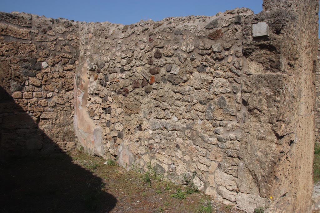 V.2.11 Pompeii. October 2023. Looking north along east wall of shop-room. Photo courtesy of Klaus Heese.